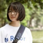 woman in white crew neck shirt wearing black framed eyeglasses