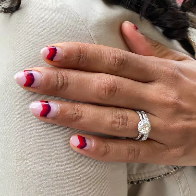 Almond-shaped nails with red and purple tonal wave stripe