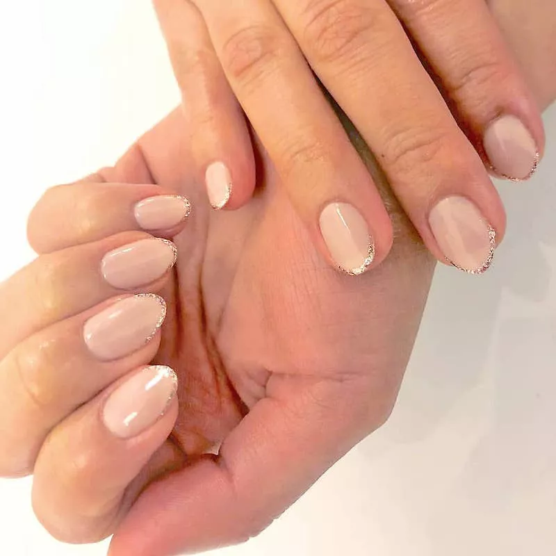 Almond-shaped French manicure with glitter tips