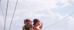 Two women sitting on a boat in the ocean