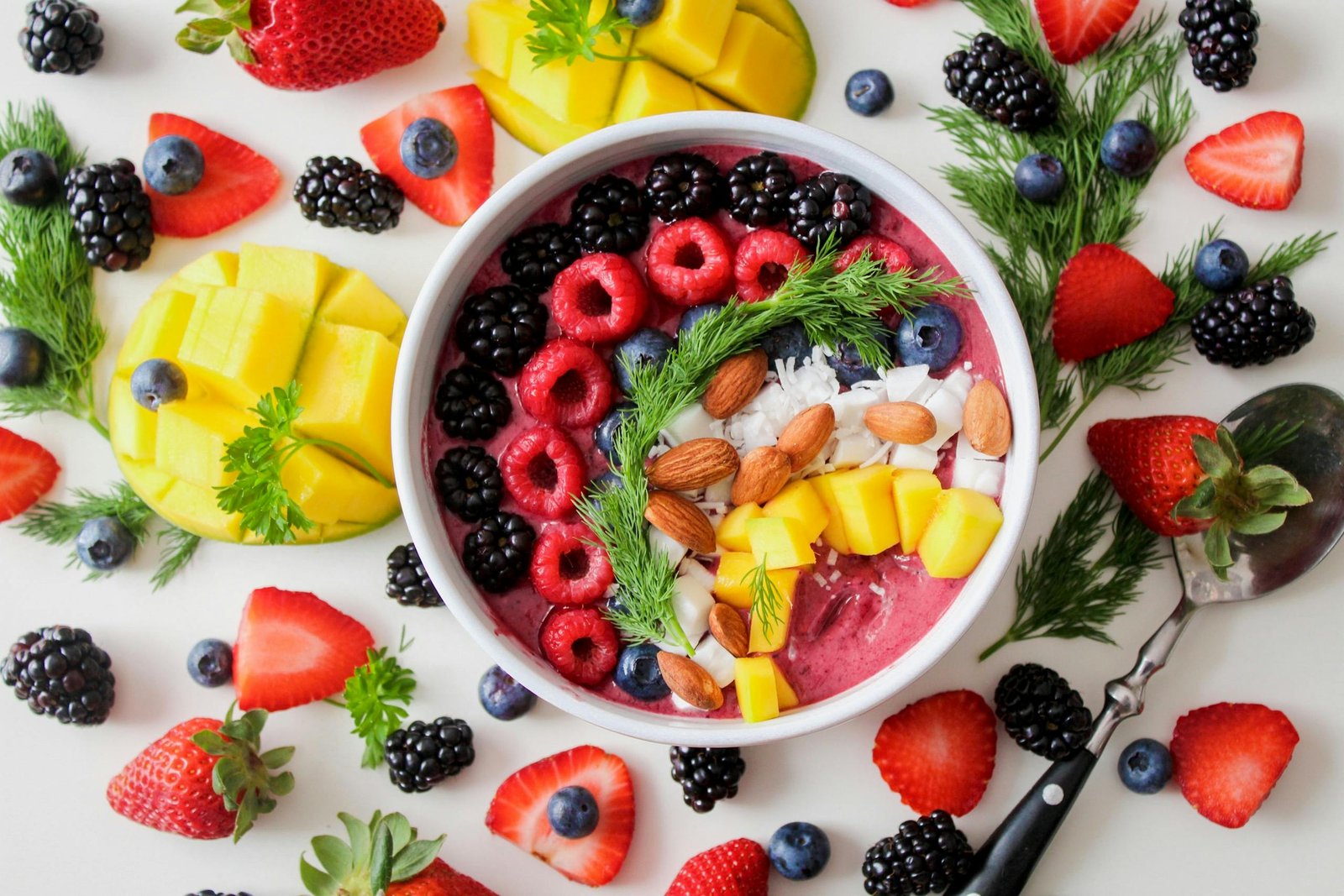 The 6 Foods That Saved Me From Another Kidney Stone Hell (And How They Can Save You Too) A vibrant, healthy fruit smoothie bowl topped with fresh berries, mango, and almonds.