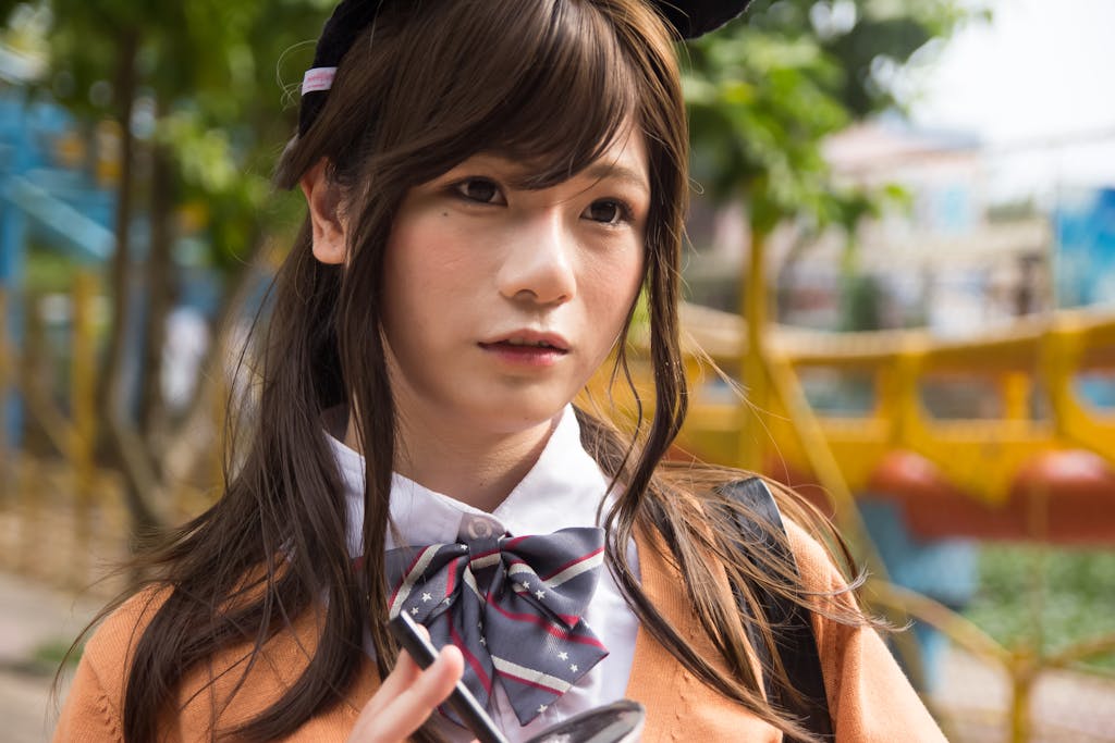 A young woman dressed in cosplay attire outdoors, blending fashion and creativity.