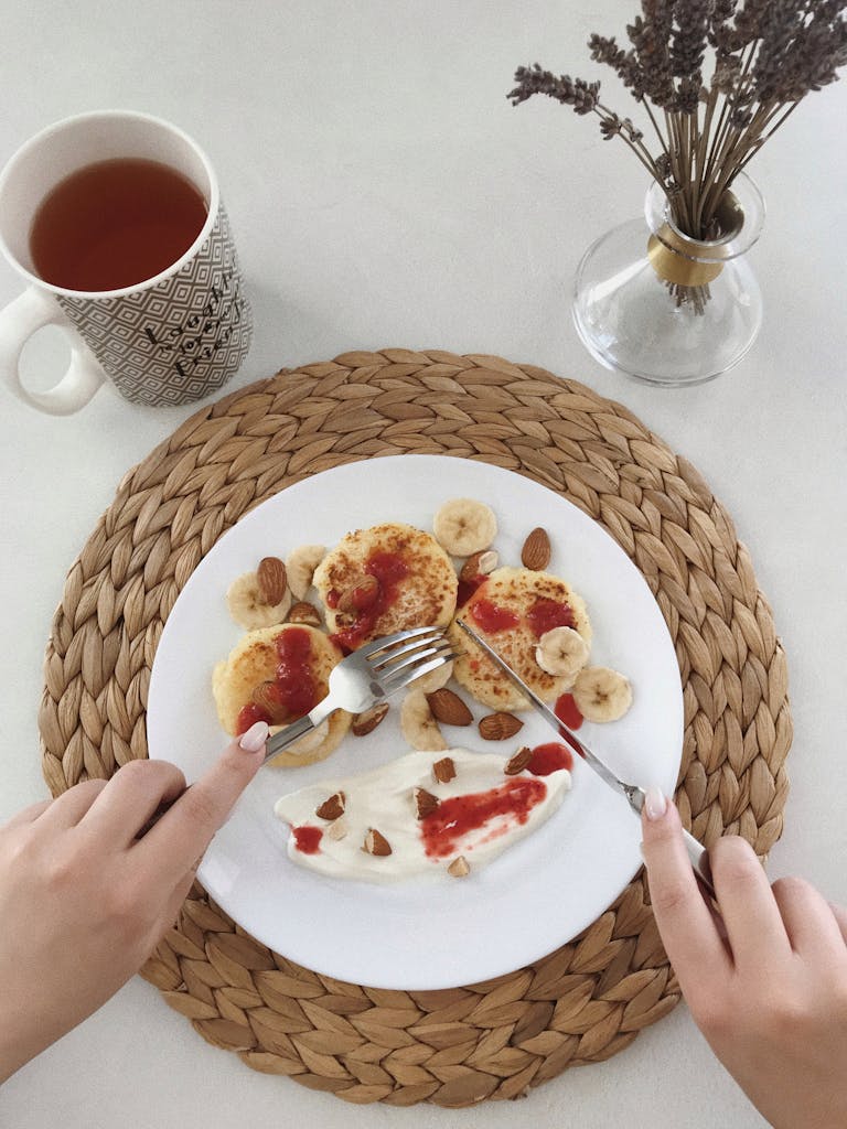 Delicious homemade pancakes with banana and almonds, served with tea.