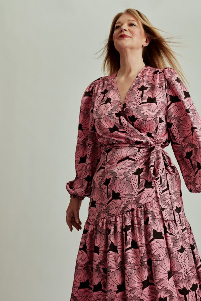 a woman in a pink and black dress