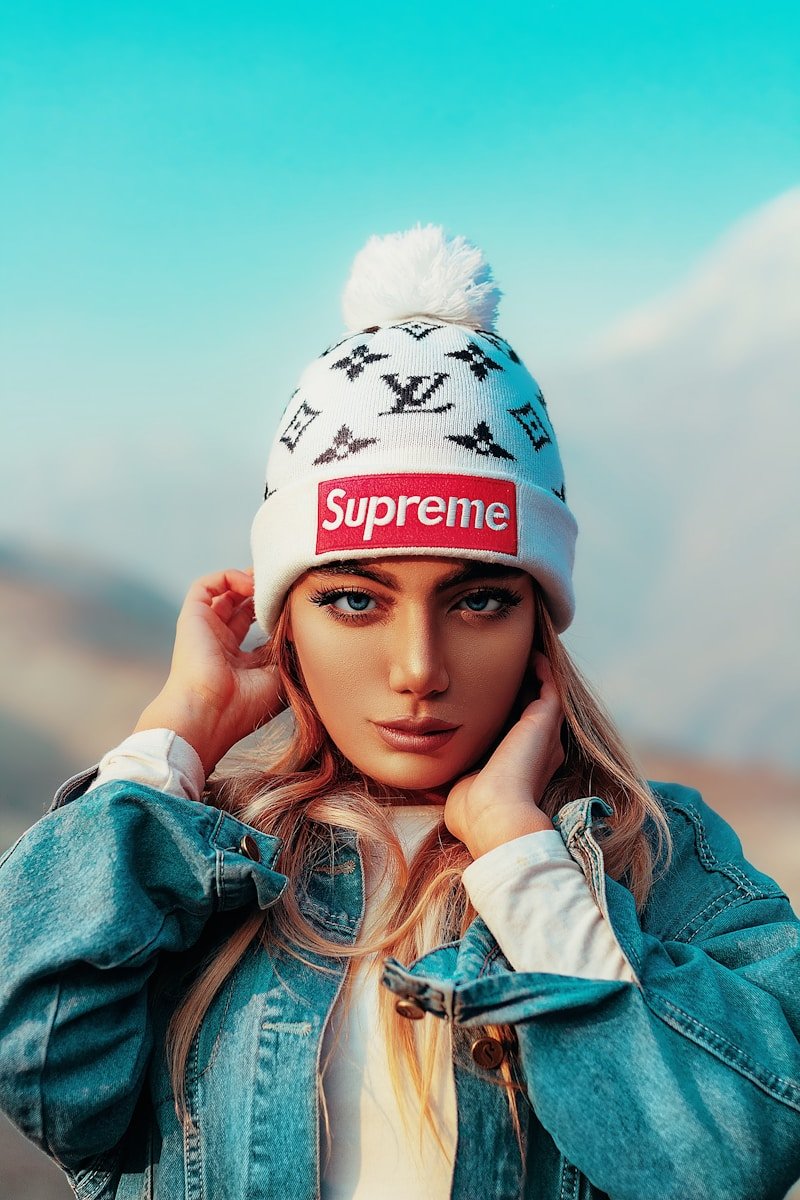 woman in blue denim jacket wearing white and blue fitted cap