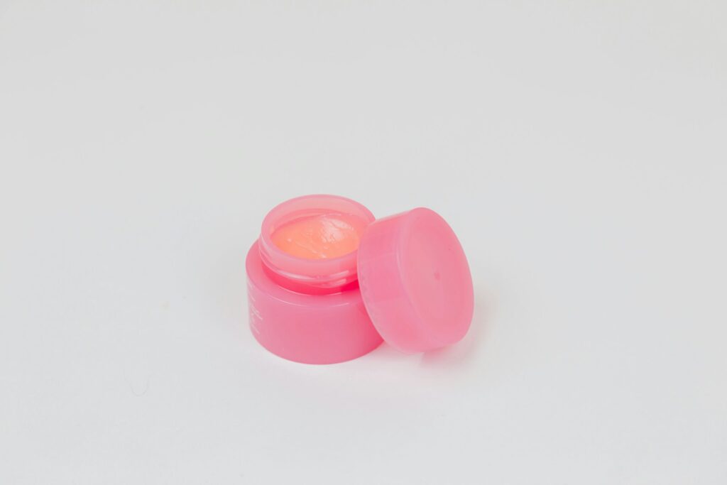pink plastic round lid on white surface