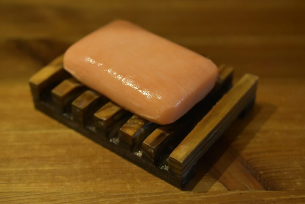 A piece of soap sitting on top of a wooden block