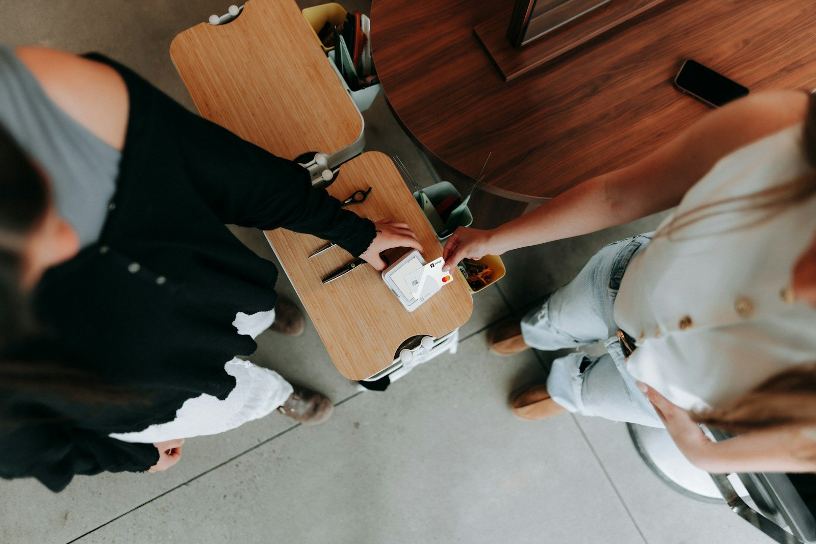 Two people are working at a table.