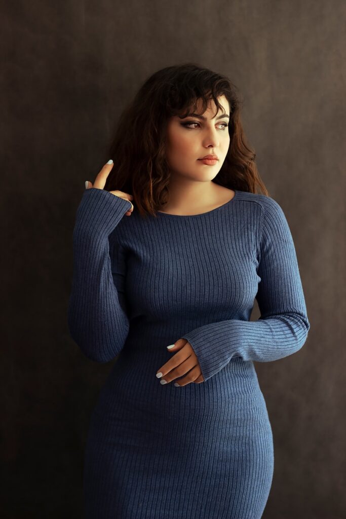 a woman in a blue dress posing for a picture