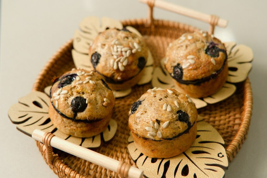 a wicker basket filled with muffins on top of a table