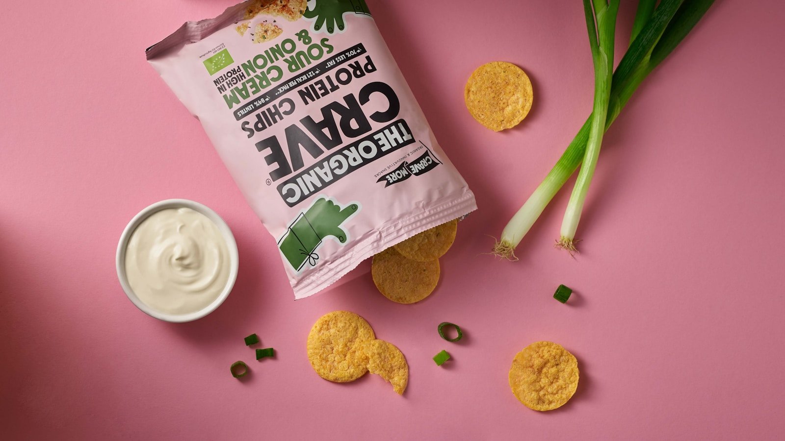 a bag of potato chips next to a bowl of sour cream