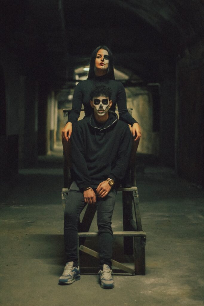 a woman sitting on top of a chair next to a man