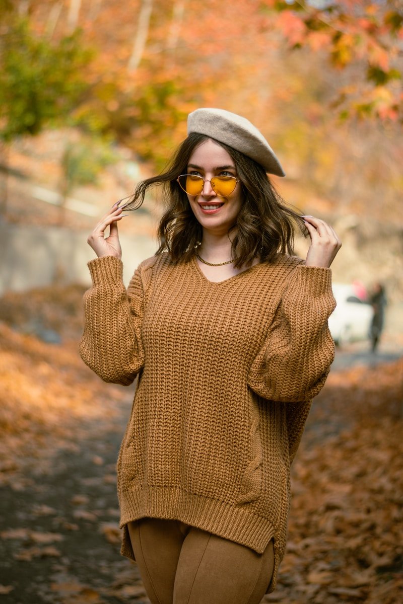 a woman in a brown sweater and a hat