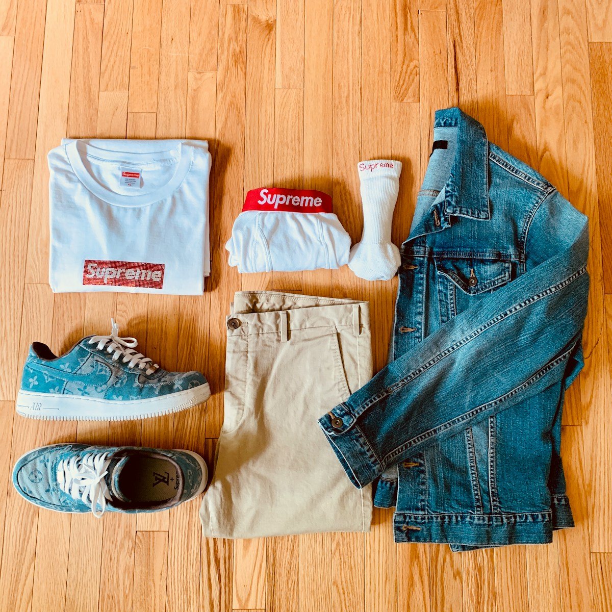 blue denim jeans and white and red crew neck shirt