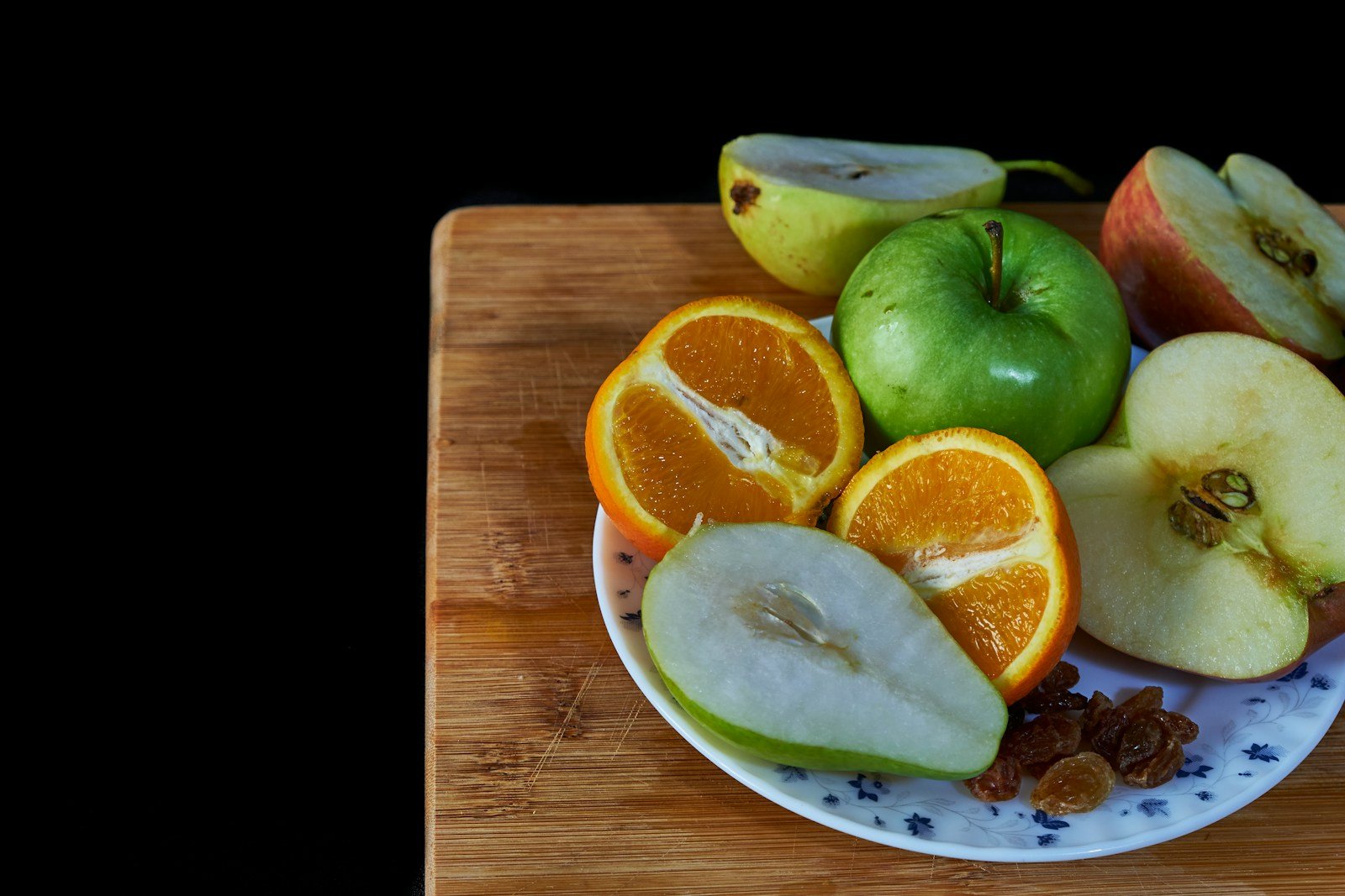a white plate topped with sliced apples and oranges