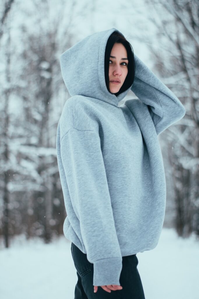 a woman wearing a hoodie in the snow