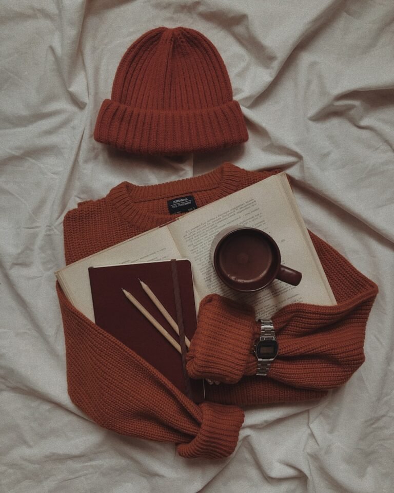 a cup of coffee and a book on a bed