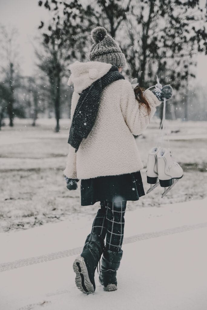 a woman walking down a snow covered street