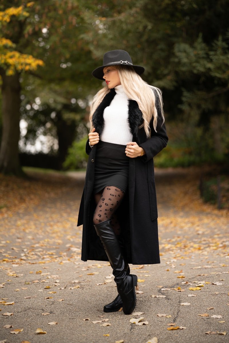 How to Style Knee-High Boots for Winter Woman in black coat and hat in autumn park