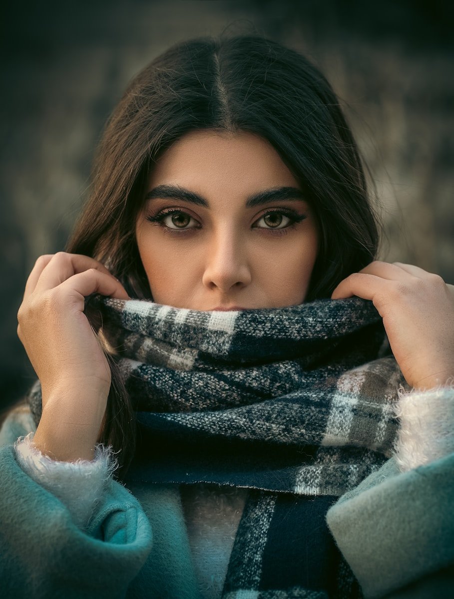 Best Winter Accessories to Upgrade Any Outfit (Scarves, Beanies & More) a woman with a scarf around her neck