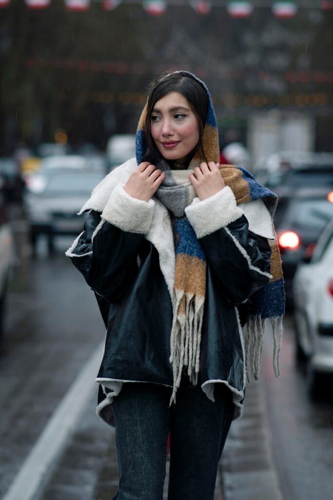 A woman walking down the street in the rain
