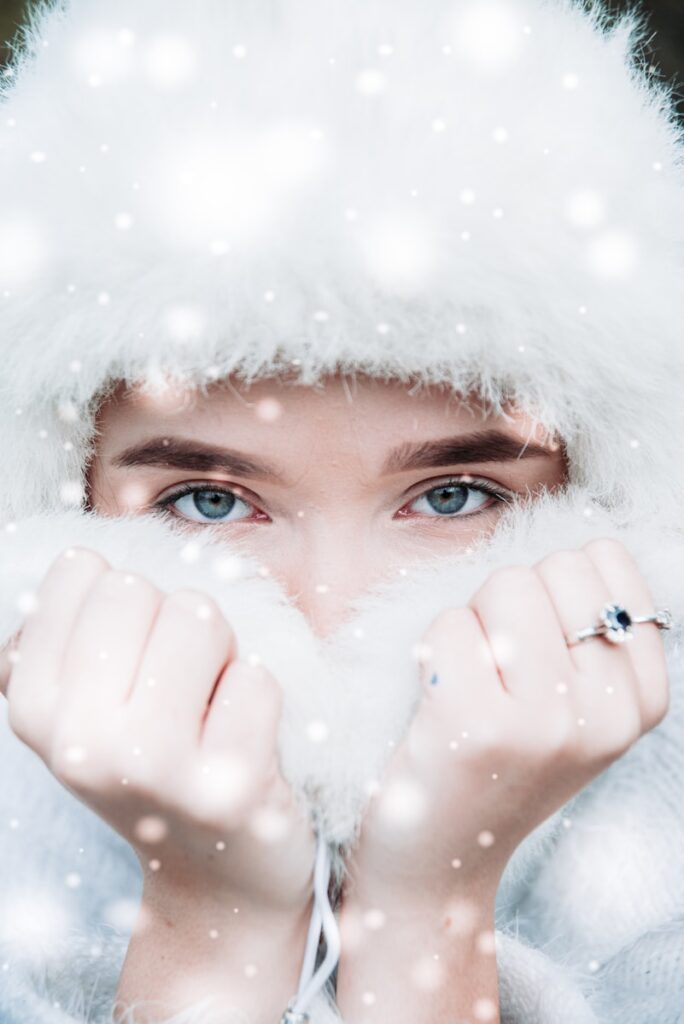 woman covering head with white fur hood