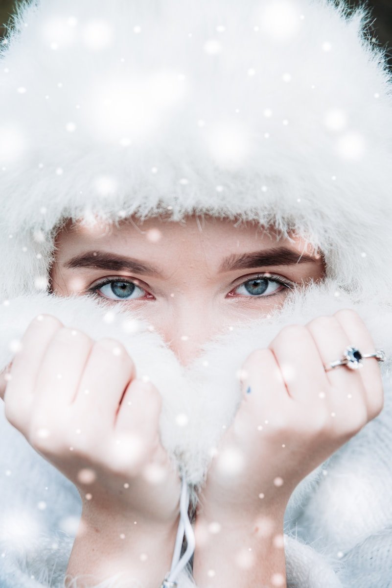 woman covering head with white fur hood