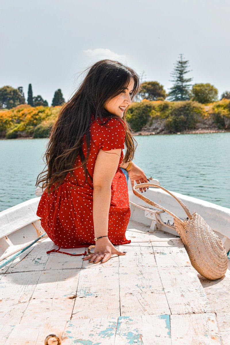 23 Wedding Guest Dresses That Hide Belly Fat and Flatter Every Body Type girl in red dress standing on dock during daytime