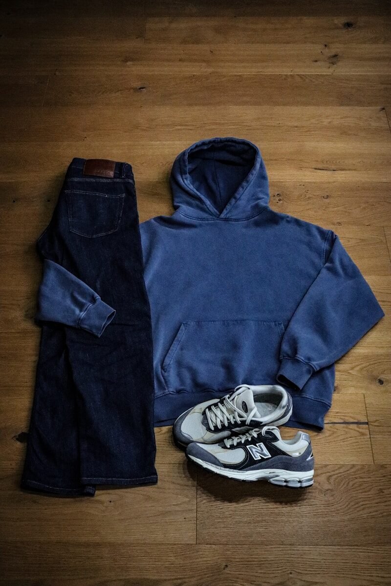 17 Last-Minute Birthday Outfit Ideas That Still Look Amazing A pair of jeans and a hoodie on a wooden floor
