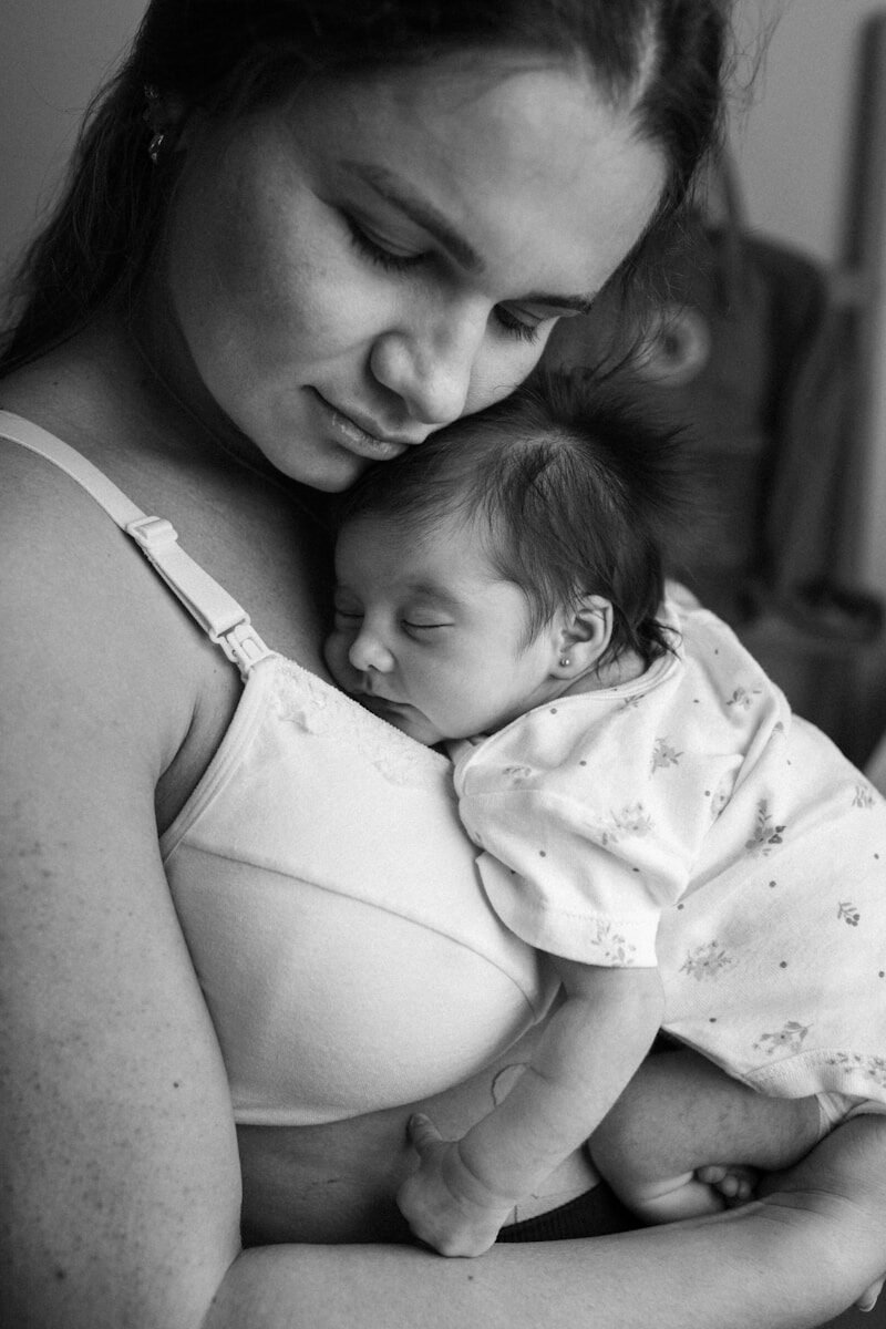 a woman holding a baby in her arms